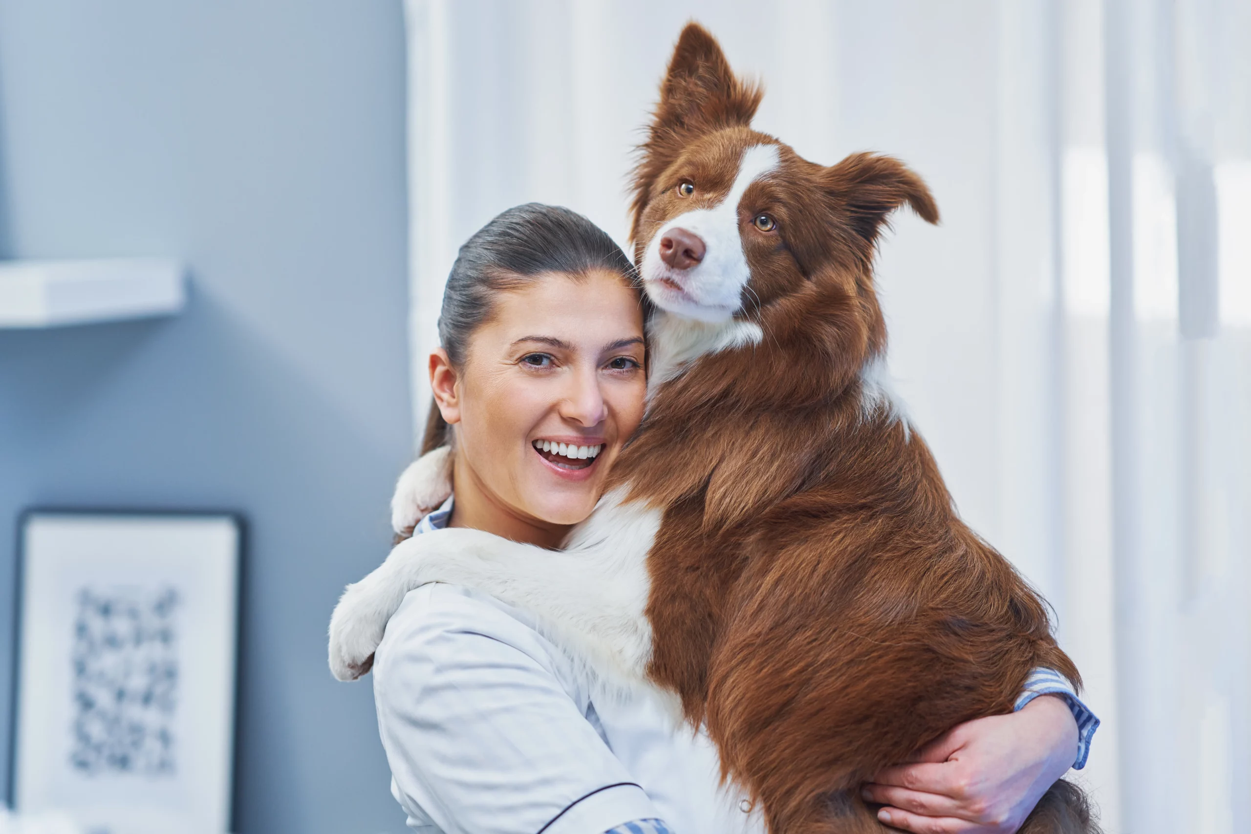 Woman holding her dog while exploring the benefits and value of pet insurance coverage in Georgia.