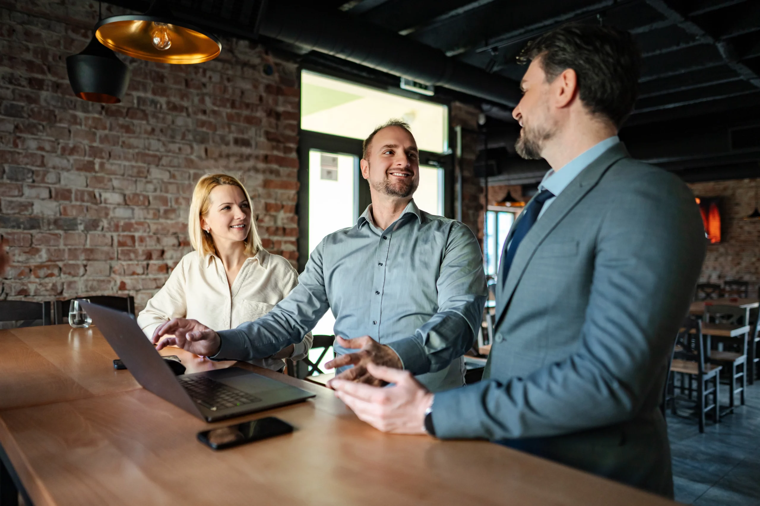 Business professionals discussing commercial umbrella insurance coverage and liability protection strategies during a collaborative business meeting.